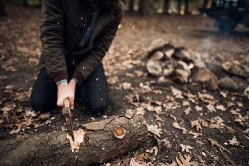 Man using an axe to cut wood