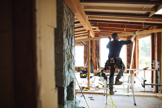 Carpentry contractor using hammer on interiour build