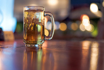 blurred glass of beer in bar background