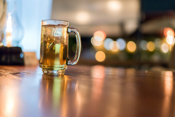 blurred glass of beer in bar background