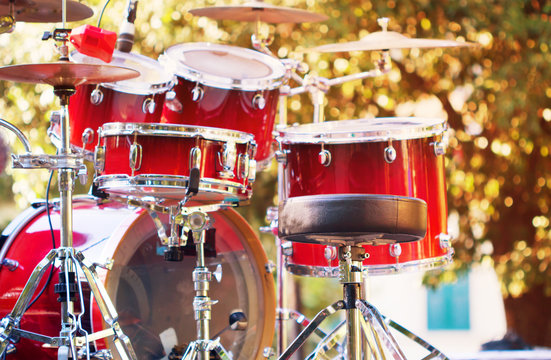 Set of drums outdoor with sunlight blurred background.