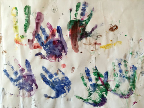 Hand prints on paper of a three year old child.