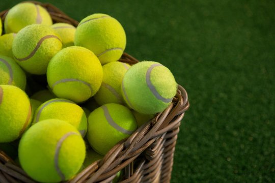 Close up of tennis balls in wicker basket