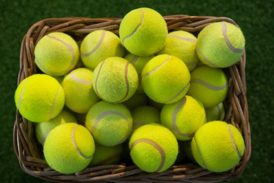 Directly above shot of tennis balls in wicker basket
