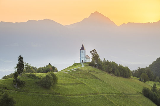 The iconic Jamik church, with Mount Triglav on the background. Jamnik, Kranj, Upper Carniola, Slovenia.