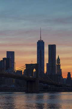 New York City - Lower Manhattan Skyline and Brooklyn Bridge against Afterglow Sky