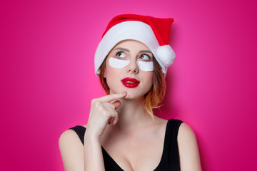 Woman using eye patch for her eyes on pink background isolated