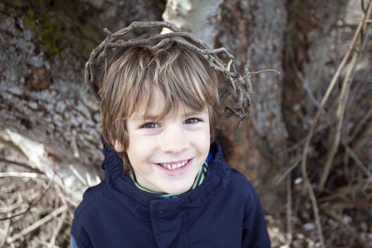 Boy wearing a crown of sticks