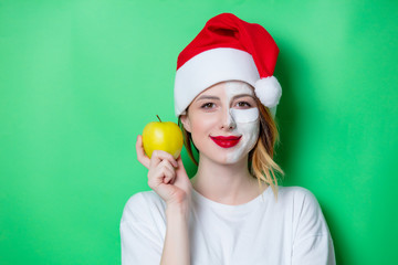 Woman using eye patch for her eyes in Santa Claus hat