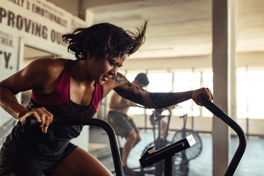 Fit young woman doing cardio workout at gym