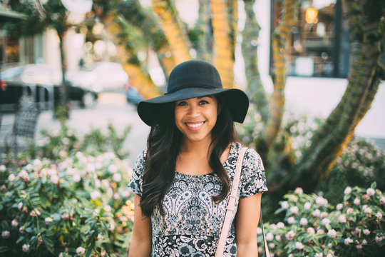 Smiling Young Woman Wearing Dress And Sun Hat