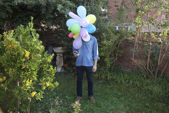 Balloon Head Man checking his cellpone