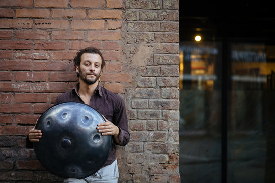 Musician with hang drum