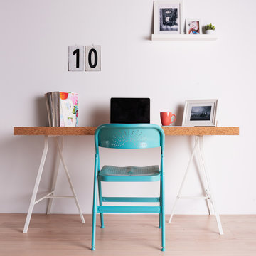 Cork table with different objects and chair near with it