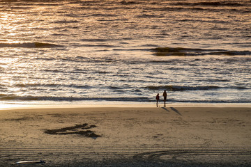 Silhouette couple on sand beach