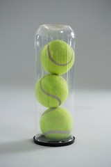 Close up of tennis ball in plastic bottle