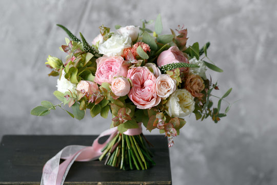 Spring bouquet of mixed flowers on vintage gray wall background behind