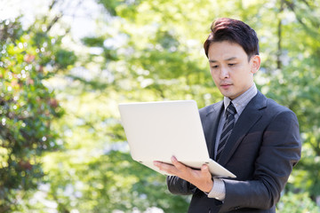 asian businessman in park