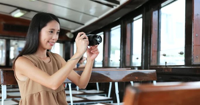Traveler taking photo with digital camera on ferry in Hong Kong