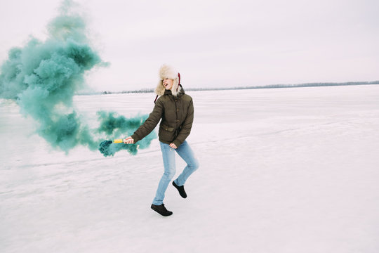 young man play with green smoke bomb