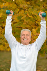 Senior man with dumbbells