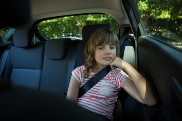 Fototapeta na wymiar Teenage girl sitting in the back seat of car