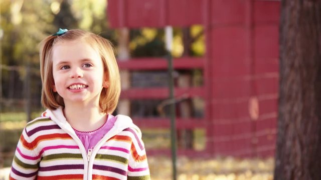 Girl smiles in autumn lane