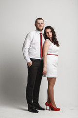 happy young couple standing on white background