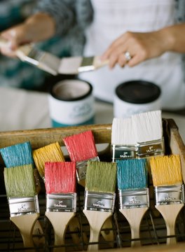 woman holding painting brushes