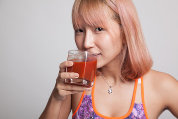 Beautiful healthy Asian girl  drink  tomato juice.