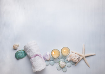 Fototapeta na wymiar Spa concept on the beach, Spa with candle and starfish shell on with wood background