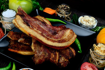 pork meat with vegetables on table