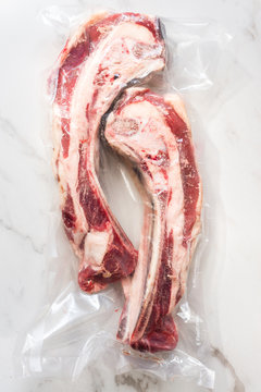 raw beef rib bones wrapped in plastic