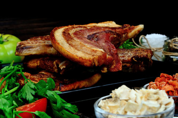 pork meat with vegetables on table