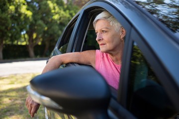 Senior woman sitting in a car