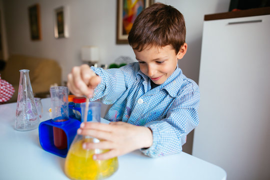 Portrait of a little boy making experiments at home.