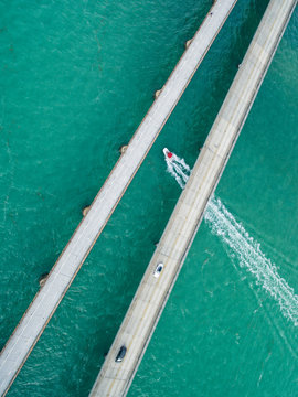 Boat traveling under the Seven Mile Bridge, Florida Keys, USA