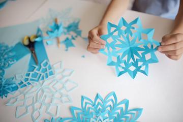 Making of snowflakes from paper.