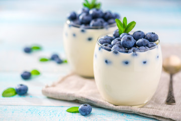 two bowl of yogurt on wooden background