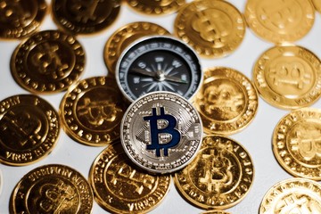 Bitcoin coin near compass