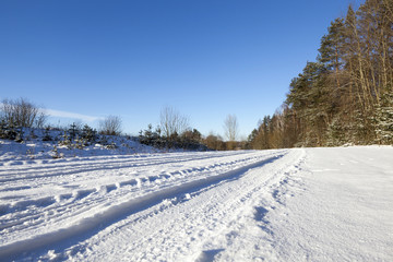 plowed agricultural field covered by snow