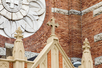 Cross on the facade of St Willebrord Catholic Church in Green Bay, WI - obrazy, fototapety, plakaty