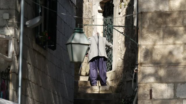 Elderly man at the old town stairs in Cavtat Croatia