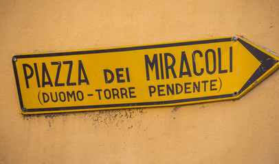 Direction sign to Miracoli Square with the Leaning Tower