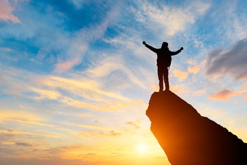 Silhouette of the man success on the peak of mountain,Sport and active life sunset landscape