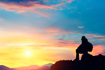 Silhouette of a man on the mountain at sunset