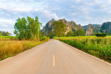 Beautiful landscape with road, mountains and blue sky. Travel concept
