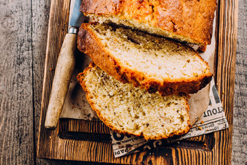 Homemade Sliced Banana Bread Cake on wooden backdrop on table background, top view, copy space for text