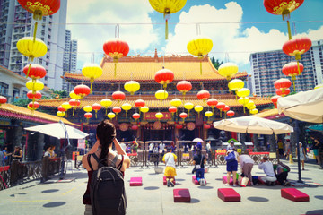 female traveler photographing temples at Wong Tai Sin Temple Hong Kong landmark