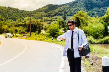 Asia young docter are looking watch at rural road .Community Health and Development Hospital In...